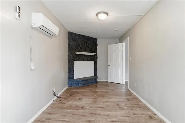 a view of an empty room with closet and a window