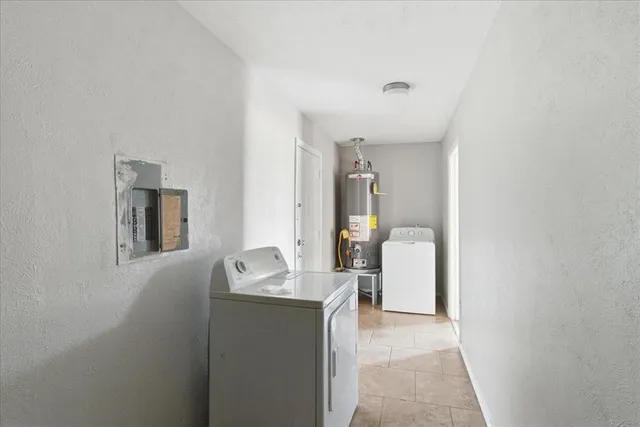 a en suite bathroom with a granite countertop sink and a mirror