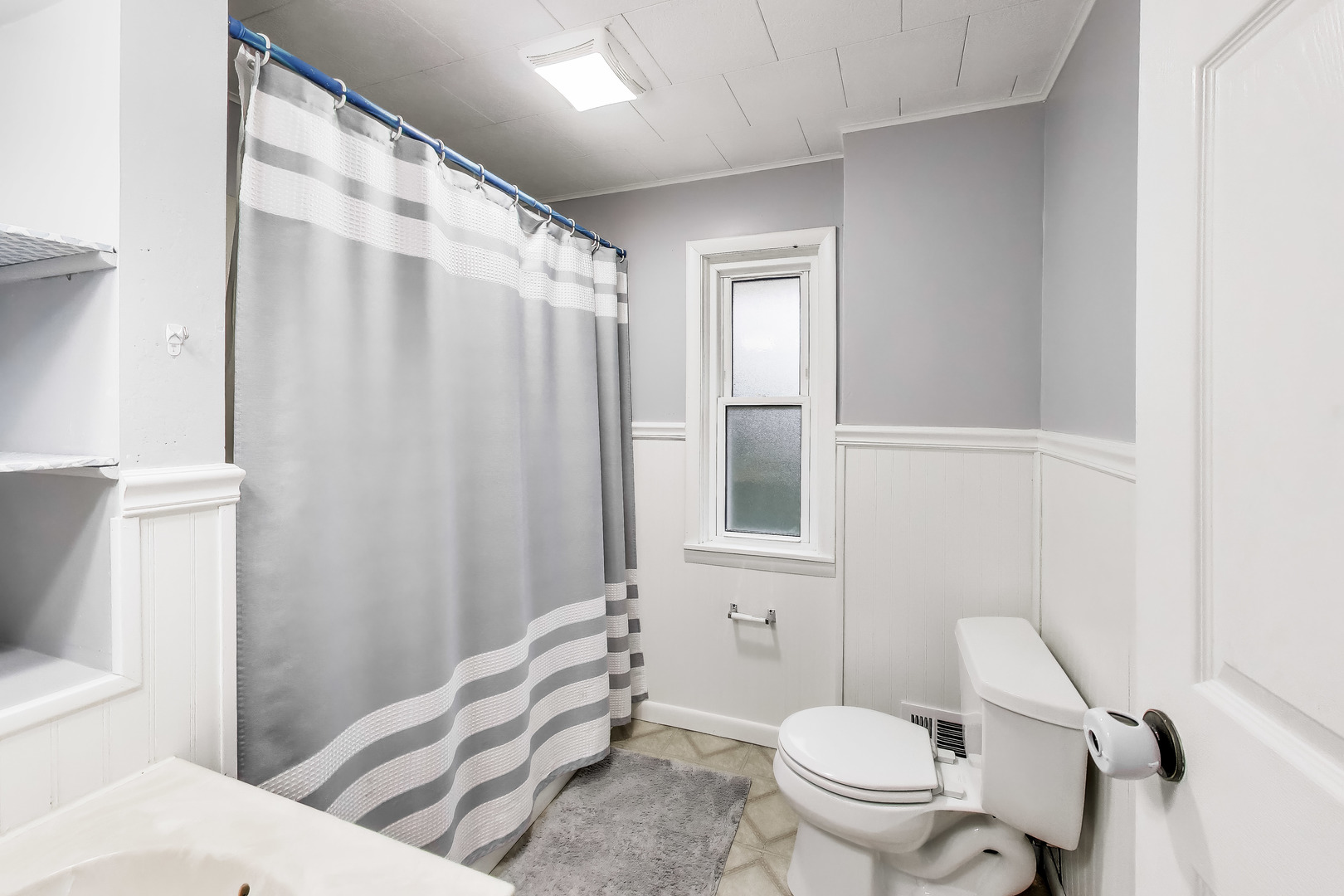 405 West Brown Street Harvard, IL 60033 - Photo 12 of 24 a white toilet sitting next to a bathroom sink and a shower
