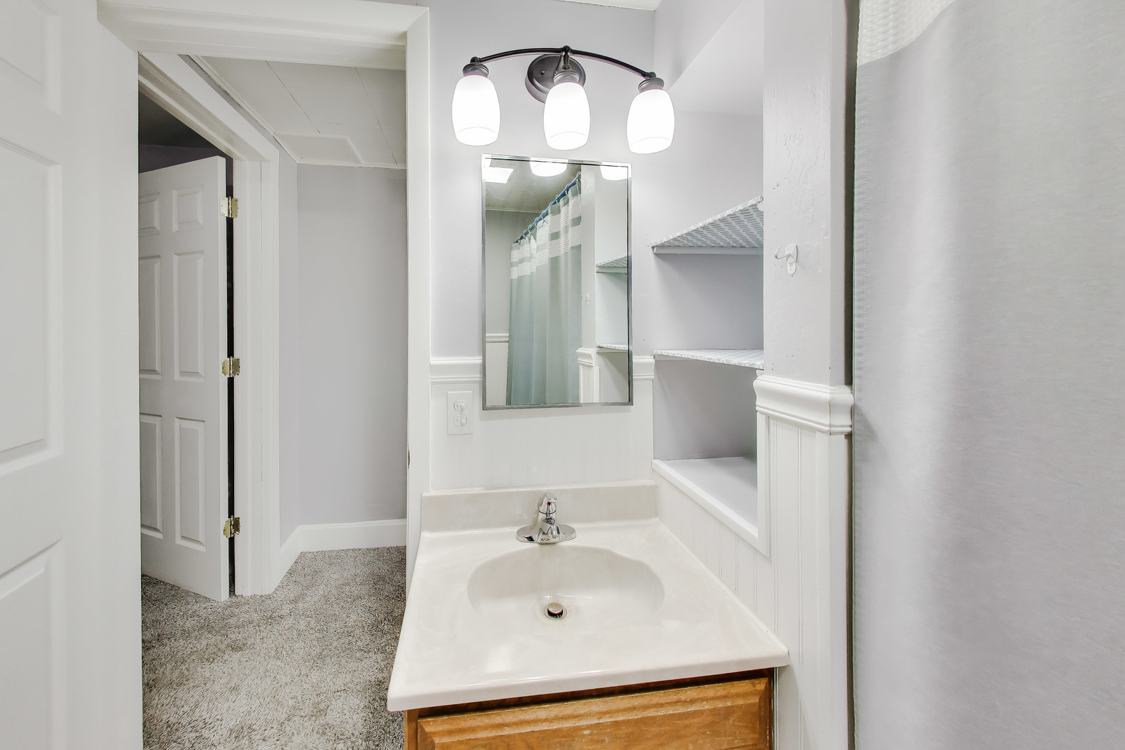 405 West Brown Street Harvard, IL 60033 - Photo 13 of 24 a bathroom with a sink and a mirror