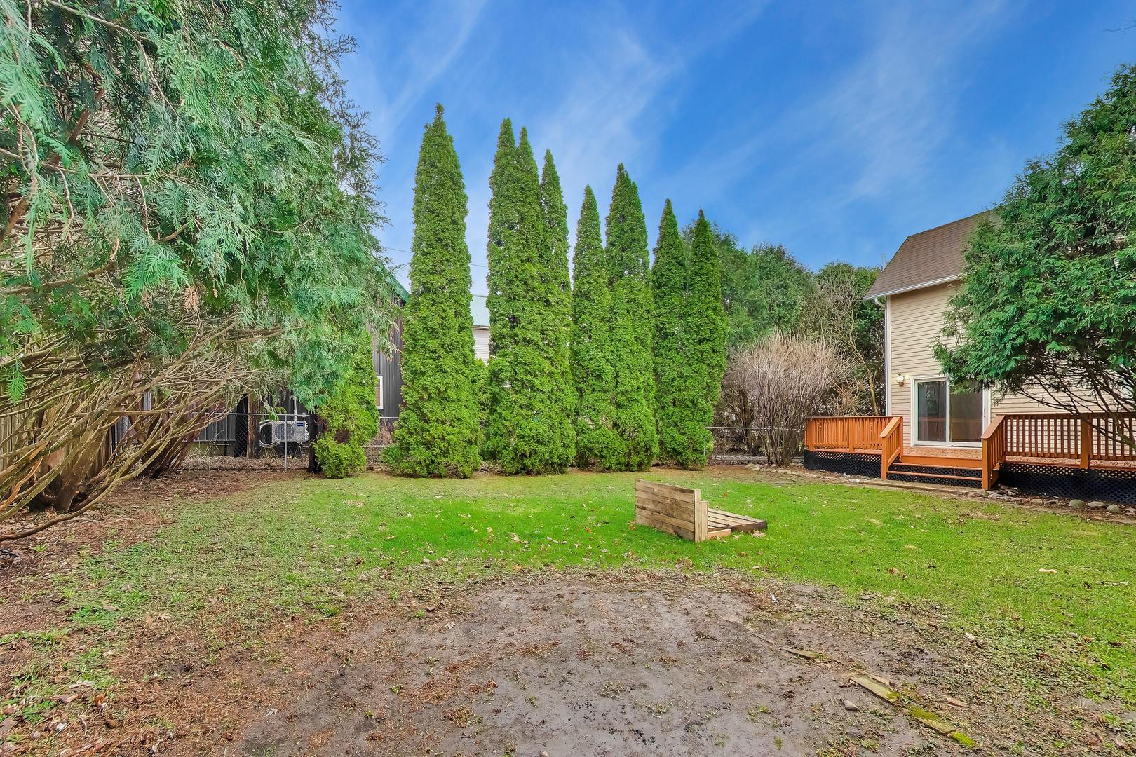 405 West Brown Street Harvard, IL 60033 - Photo 18 of 24 a view of a backyard with a house
