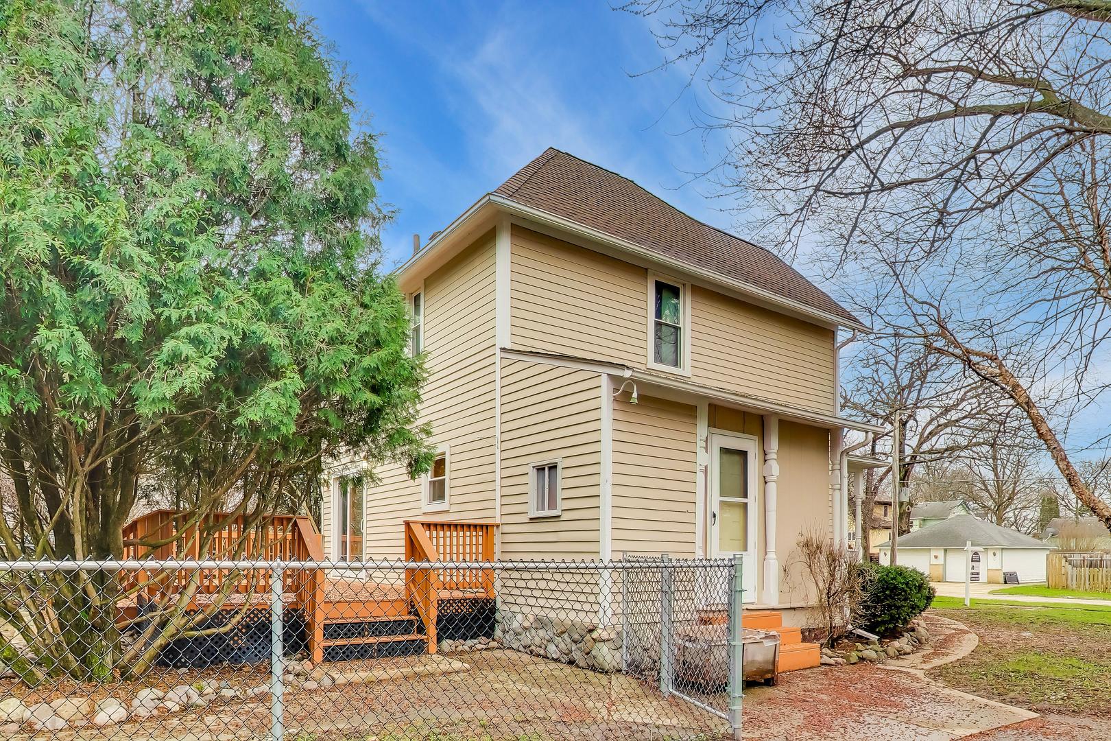 405 West Brown Street Harvard, IL 60033 - Photo 19 of 24 a front view of a house with a tree