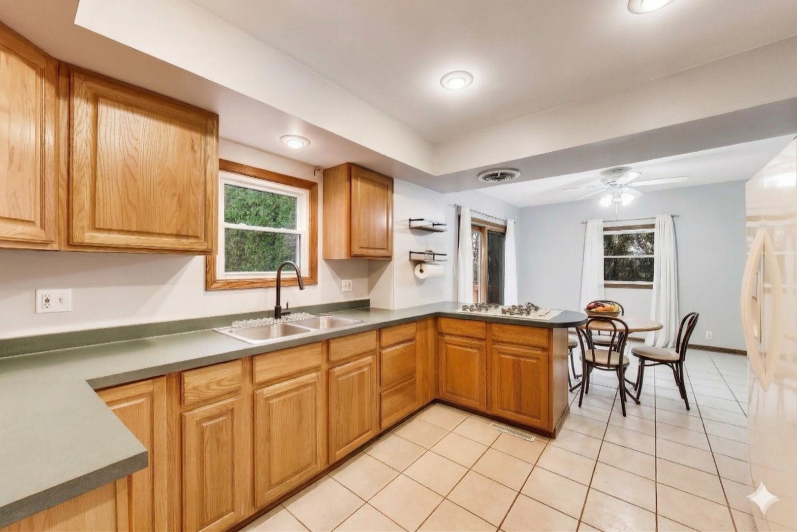 405 West Brown Street Harvard, IL 60033 - Photo 5 of 24 a kitchen with stainless steel appliances granite countertop a sink and cabinets