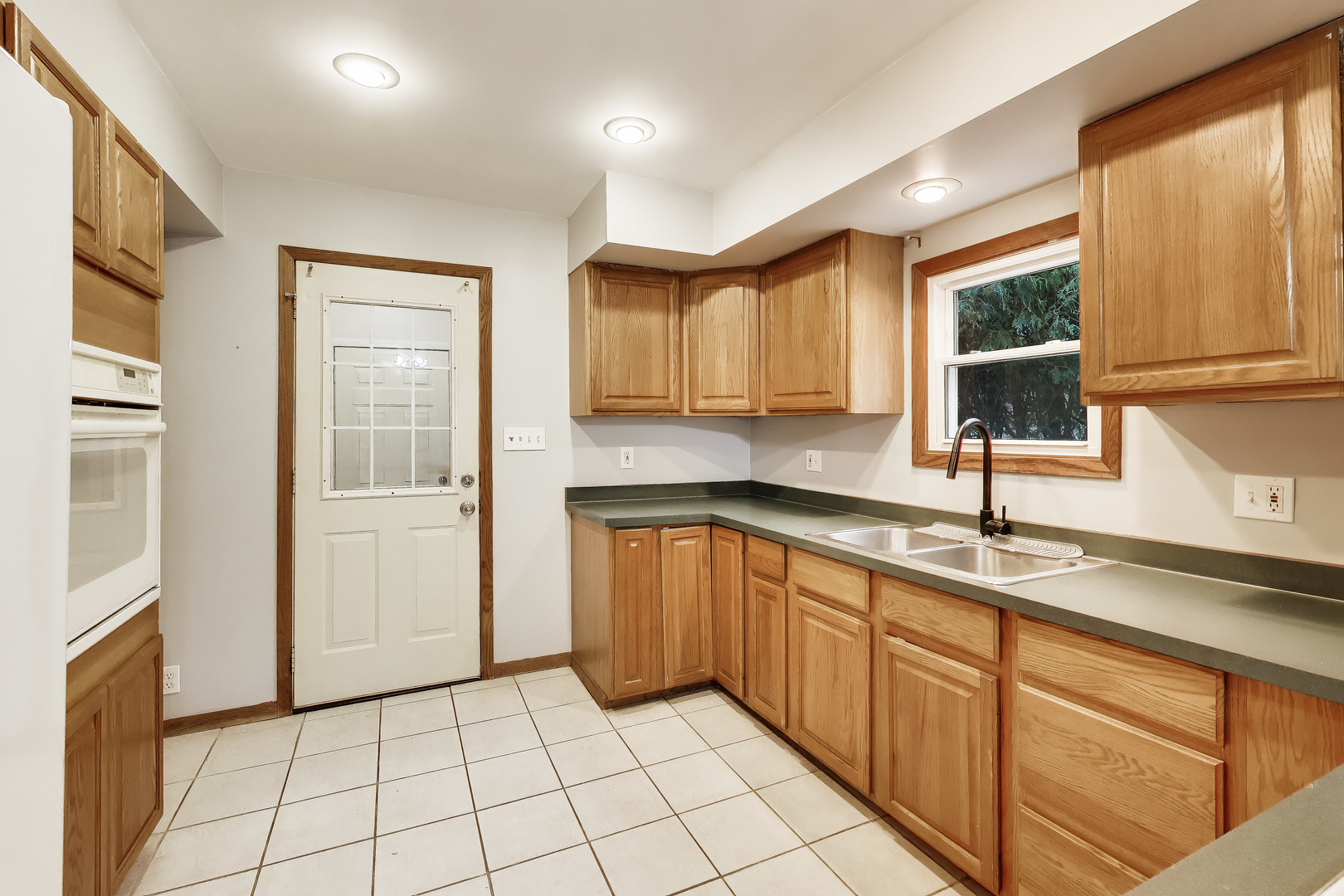 405 West Brown Street Harvard, IL 60033 - Photo 7 of 24 a kitchen with stainless steel appliances granite countertop a sink and a stove