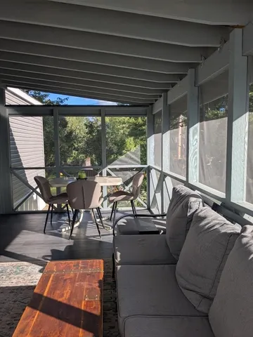 a view of a patio with table and chairs and wooden floor