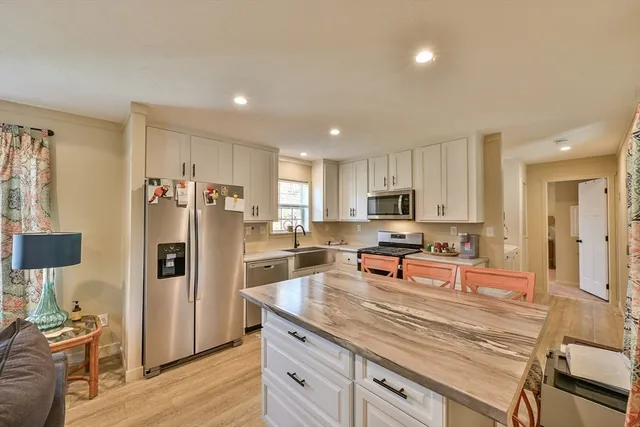 a kitchen with granite countertop a stove and a sink