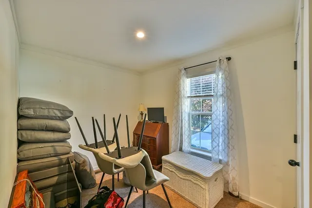 a bedroom with a bed and a chair