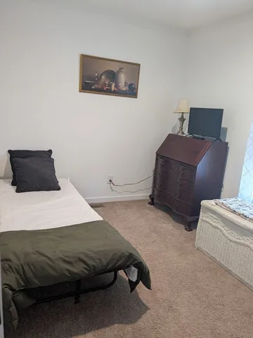 a room with a bed and a window