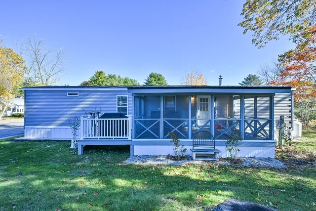 a view of a house with a yard and deck