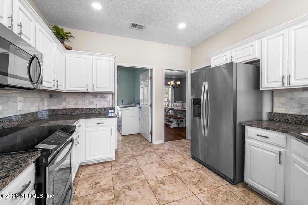 3734 Reedpond Drive North Jacksonville, FL 32223 - Photo 21 of 55 a kitchen with granite countertop a refrigerator stove and sink