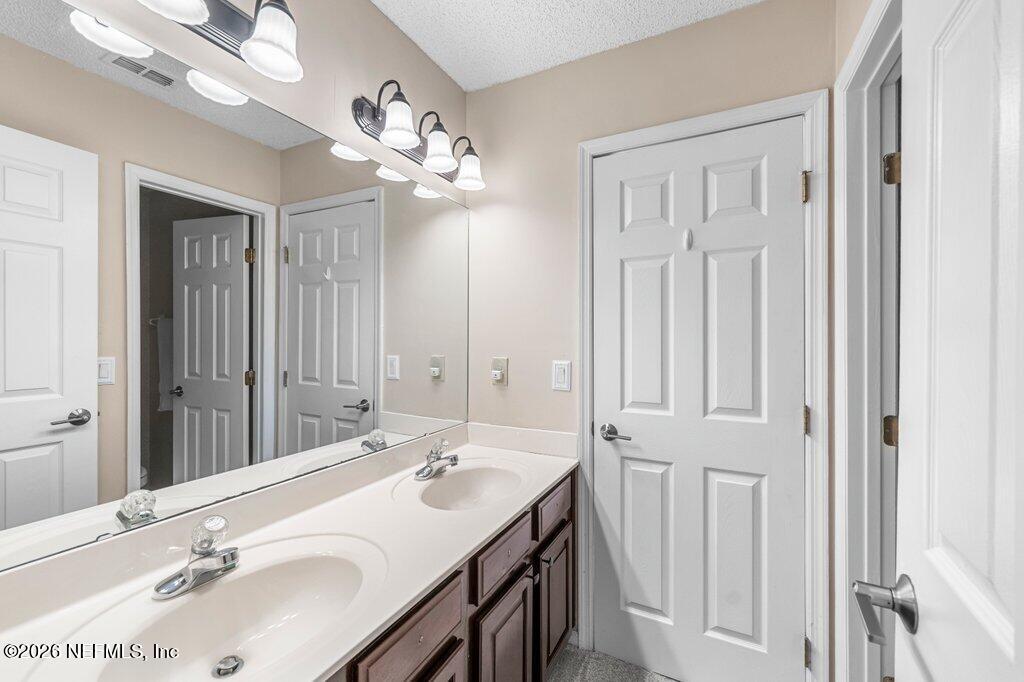 3734 Reedpond Drive North Jacksonville, FL 32223 - Photo 37 of 55 a bathroom with a double vanity sink a vanity and a mirror