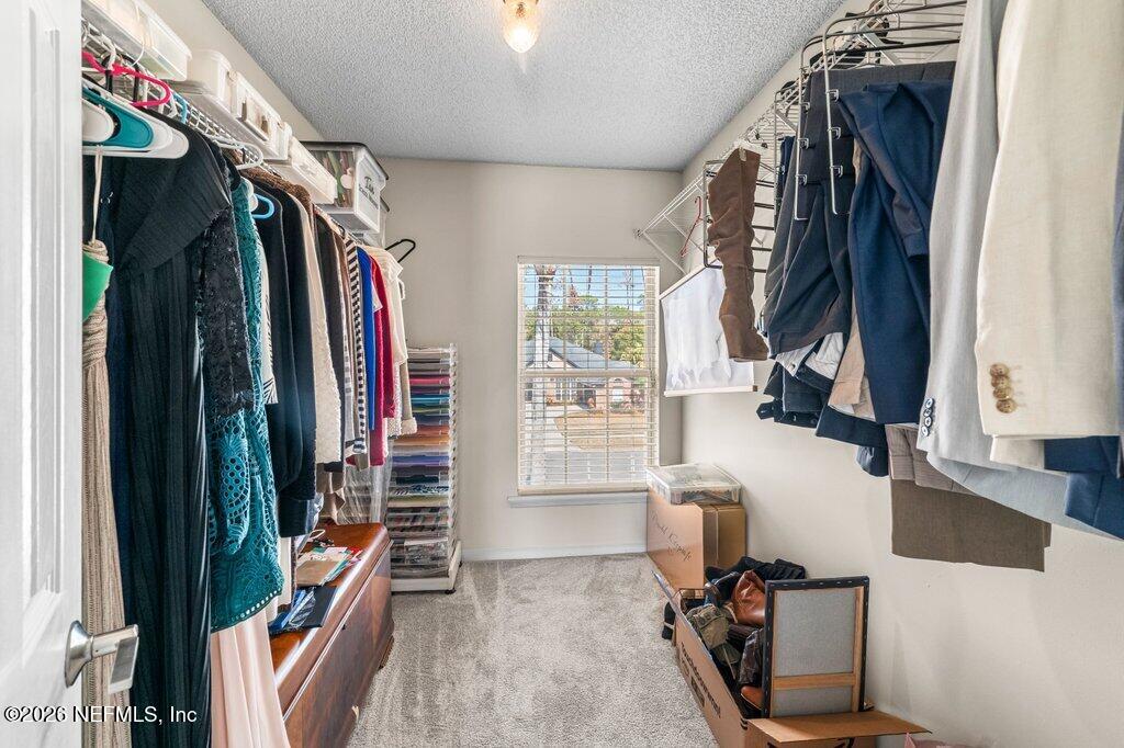 3734 Reedpond Drive North Jacksonville, FL 32223 - Photo 41 of 55 a view of walk in closet with clothes and shoes