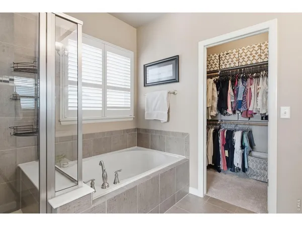 a bathroom with a tub and a shower