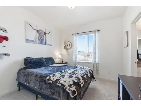 a bedroom with a bed and a lamp with window