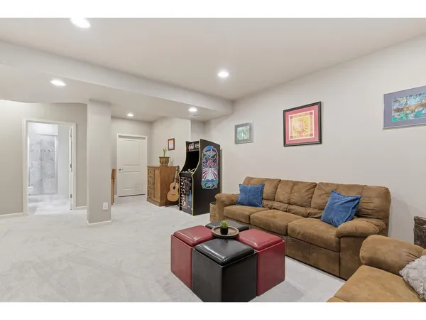 a living room with furniture kitchen view and a couch