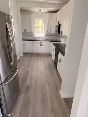 a kitchen with cabinets and stainless steel appliances