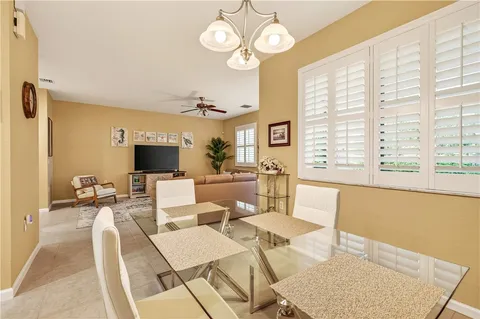 a living room with furniture a flat screen tv and a large window