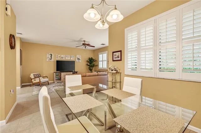 a living room with furniture a flat screen tv and a large window