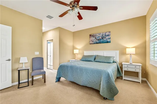 a bedroom with a bed and a chair