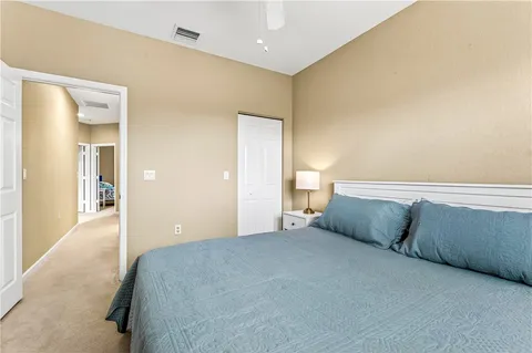 a bedroom with a bed and cabinets