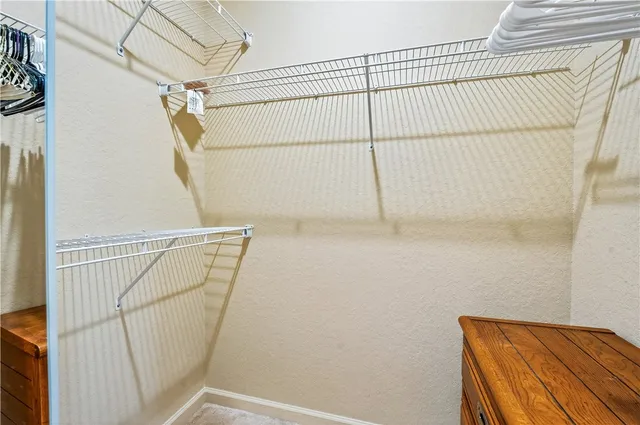 a view of walk in closet with clothes