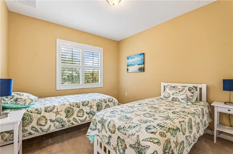 a bedroom with two beds and a window