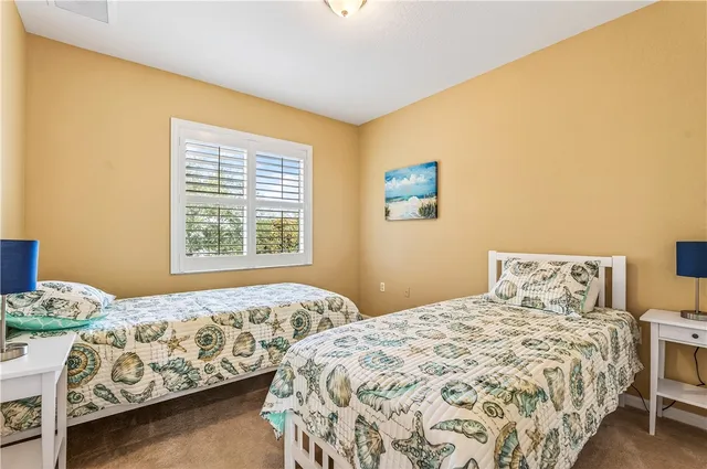 a bedroom with two beds and a window