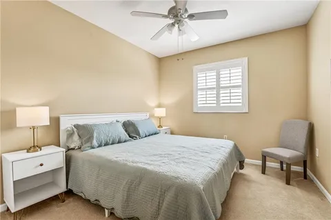 a bedroom with a bed and a chair