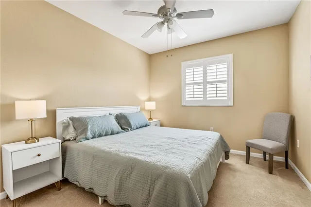 a bedroom with a bed and a chair