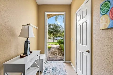 a view of a hallway with furniture and a window