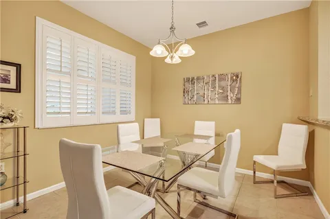 a view of a dining room with furniture and a large window