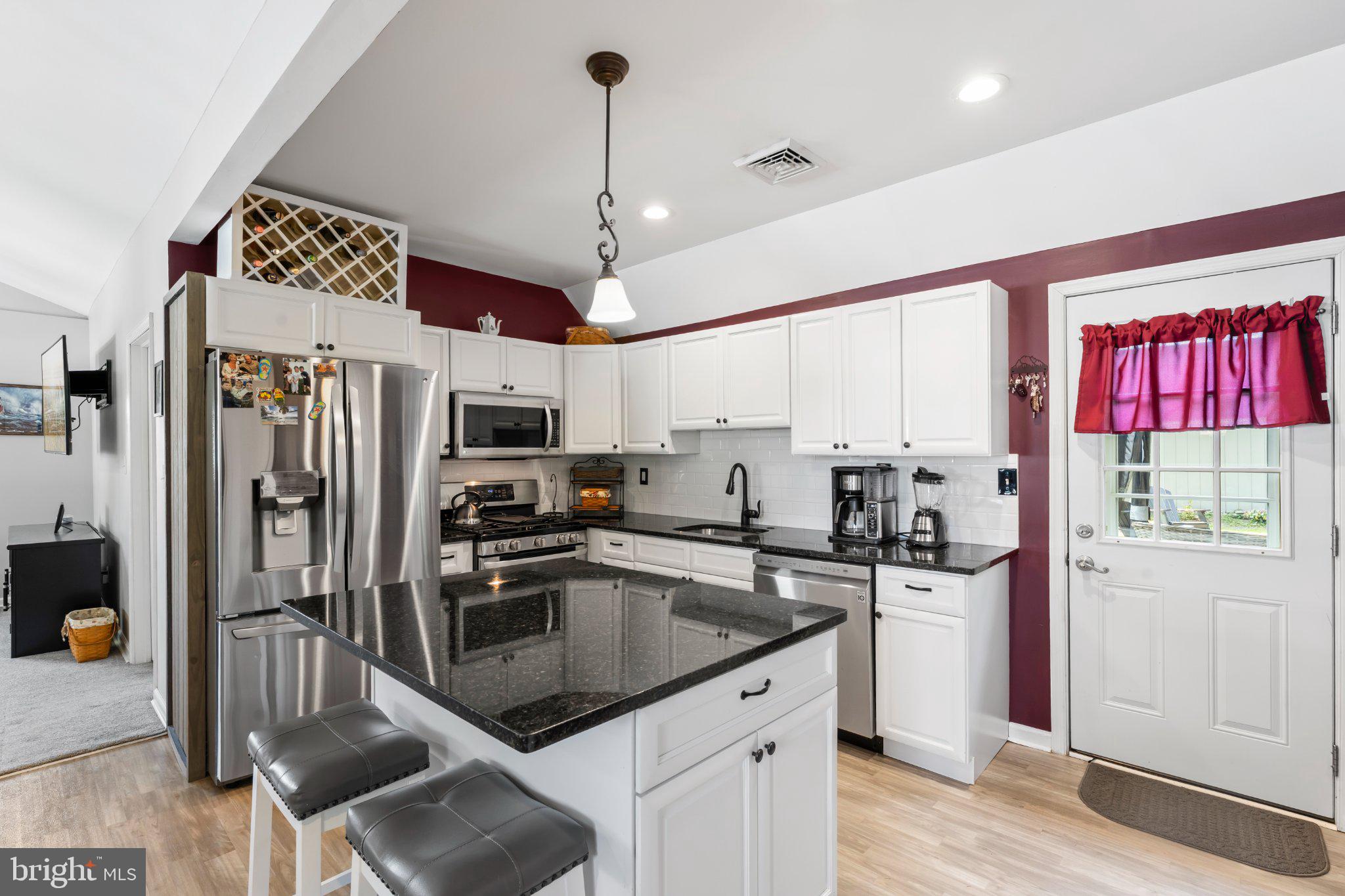 1748 Larkin Road Upper Chichester, PA 19061 - Photo 26 of 32 a kitchen with stainless steel appliances granite countertop a sink a stove and a refrigerator