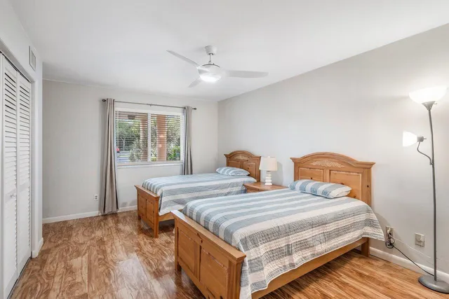 a bedroom with two beds and a window