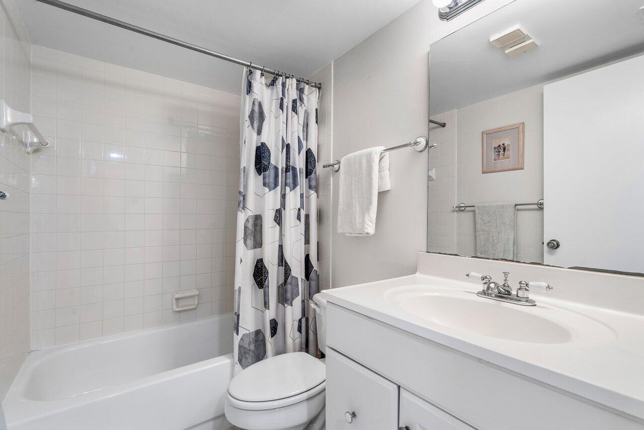 353 Highway 1, Unit F109 Jupiter, FL 33477 - Photo 17 of 22 a bathroom with a sink toilet and shower