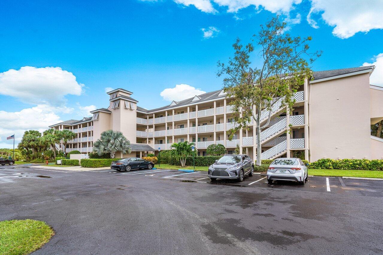 353 Highway 1, Unit F109 Jupiter, FL 33477 - Photo 2 of 22 a car parked in front of a building