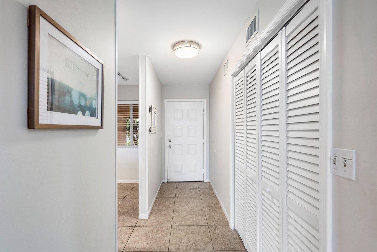 353 Highway 1, Unit F109 Jupiter, FL 33477 - Photo 3 of 22 a view of a hallway with wooden floor and windows