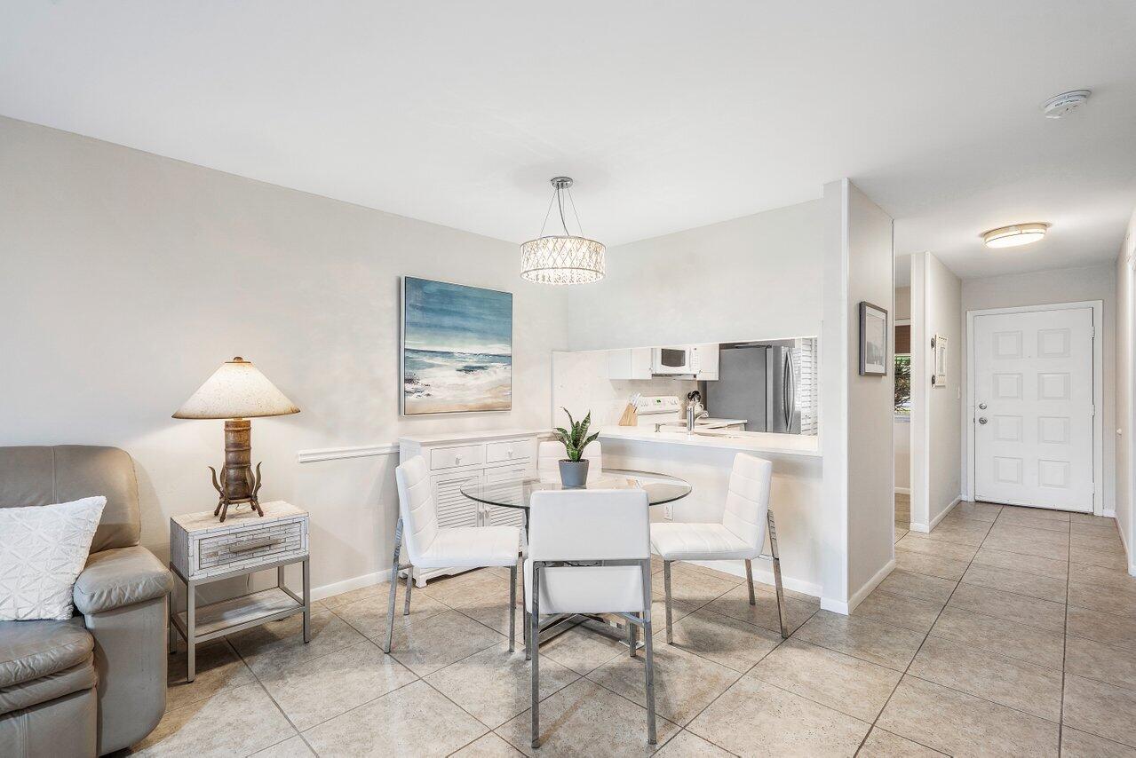 353 Highway 1, Unit F109 Jupiter, FL 33477 - Photo 4 of 22 a dining room with furniture and a chandelier
