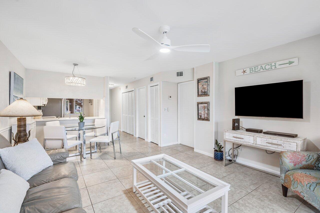 353 Highway 1, Unit F109 Jupiter, FL 33477 - Photo 9 of 22 a living room with furniture and a flat screen tv
