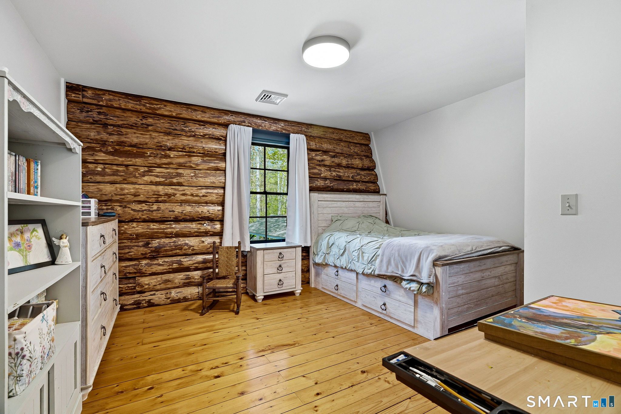 61 Mystic Road North Stonington, CT 06359 - Photo 7 of 40 a bedroom with furniture and a book shelf