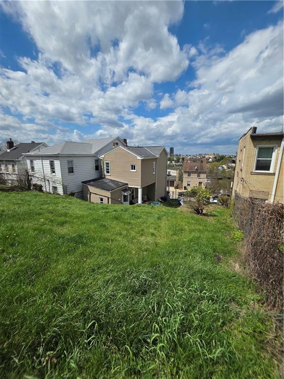 311 Natchez Street Pittsburgh, PA 15211 - Photo 5 of 12 a car parked in front of a house with a big yard