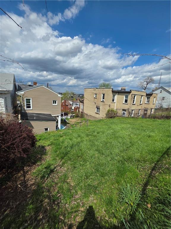 311 Natchez Street Pittsburgh, PA 15211 - Photo 7 of 12 a view of a house with a yard and sitting area