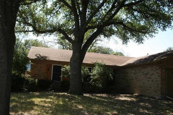 a view of a house with a tree