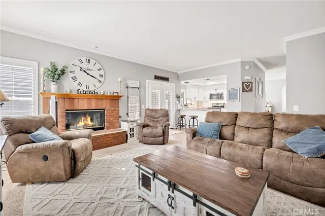 a living room with furniture fireplace and a large window