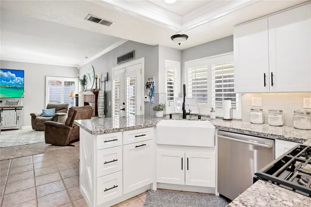 a kitchen with white cabinets and white appliances