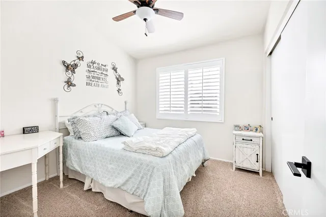a spacious bedroom with a bed and a chandelier