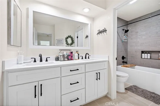 a spacious bathroom with a granite countertop sink mirror and toilet