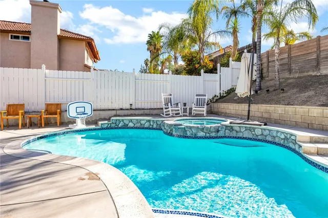 a backyard of a house with table and chairs