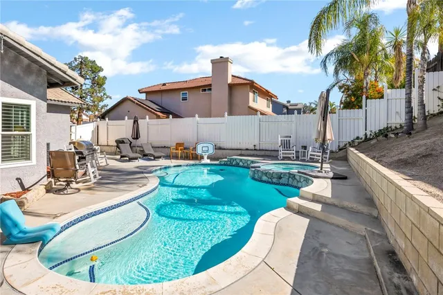 a swimming pool with outdoor seating