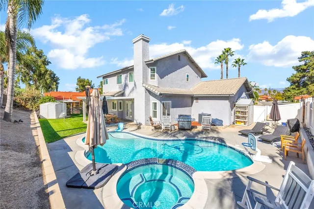 a view of a house with backyard sitting area and furniture