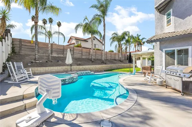 a swimming pool with outdoor seating and yard